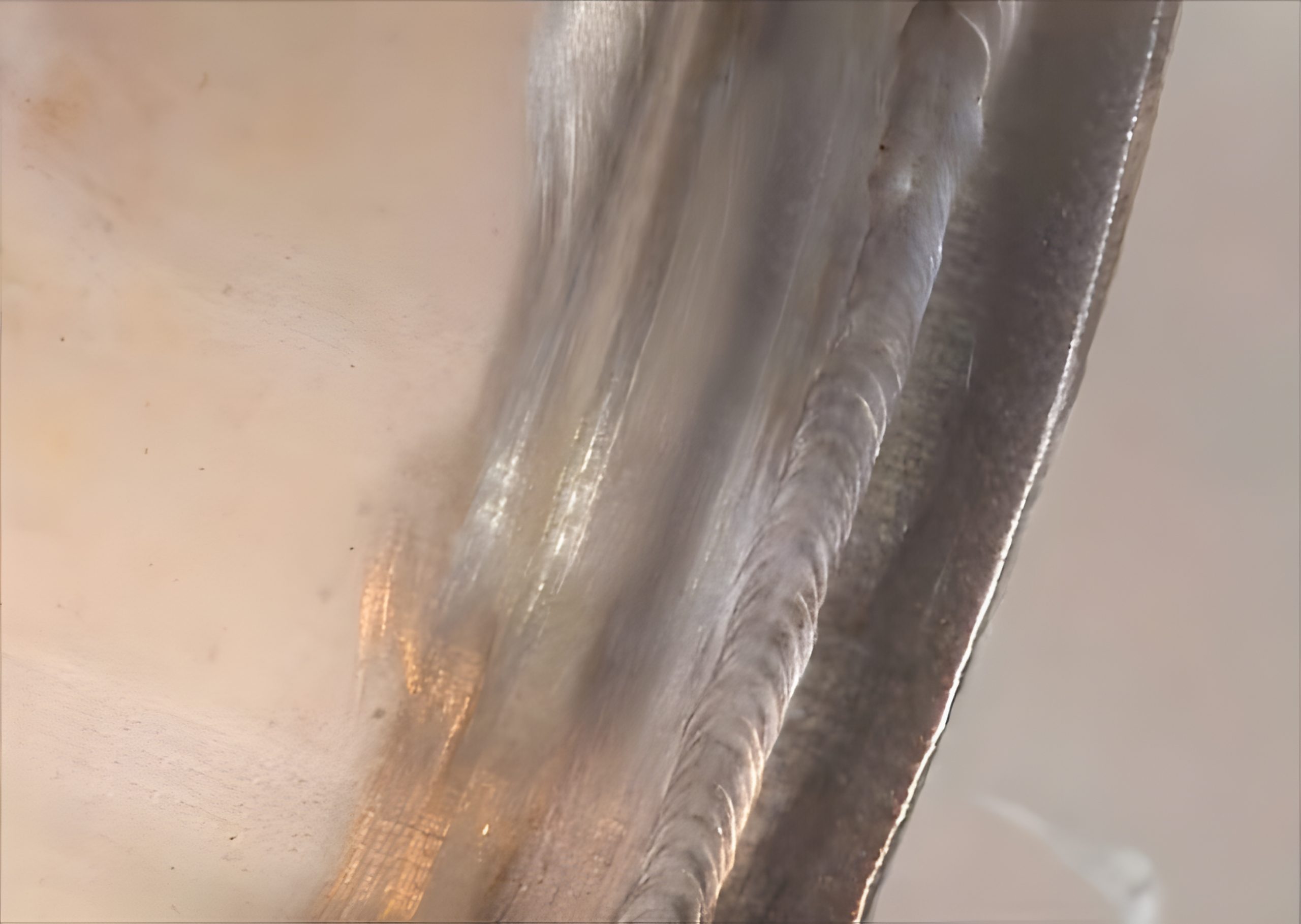 Close-up of welding bead on metal surface.