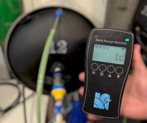 Hand holding a weld purge monitor.