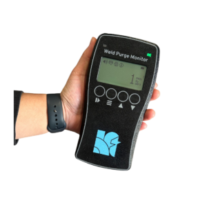 Hand holding a weld purge monitor device.
